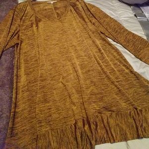Gold and black tunic with ruffle edging.